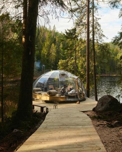 a boat in a glass dome on a dock at Magical Igloo By The Water In Helgeroa in Larvik