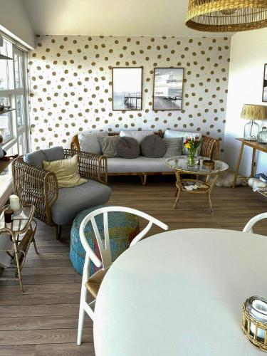 a living room with a couch and a table at Fjord-Side Cottage In Munkebo By The Water in Munkebo