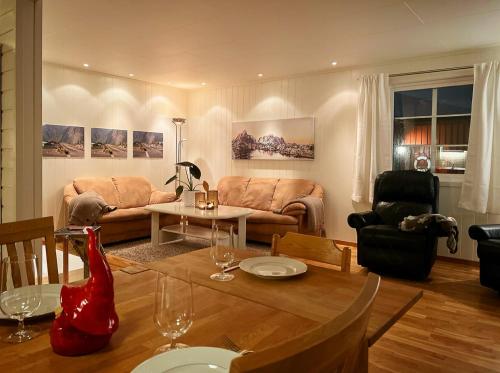 a living room with a couch and a table at Cosy Cabin On Jetty In Lofoten in Skrova