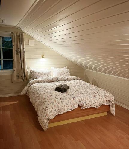 a bed with a stuffed animal on it in a bedroom at Cosy Cabin On Jetty In Lofoten in Skrova