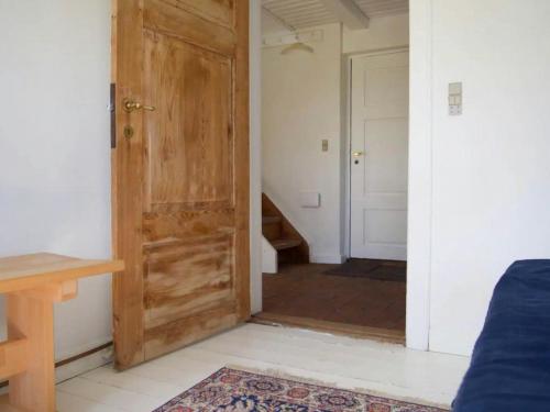 a room with a wooden door and a hallway at Charming Farmhouse From 1875 Near Stevns Klint in Rødvig