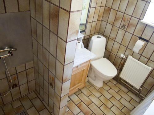 a small bathroom with a toilet and a sink at Charming Farmhouse From 1875 Near Stevns Klint in Rødvig