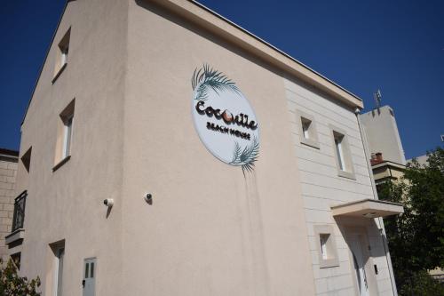 a building with a sign on the side of it at CoCo Villa in Makarska
