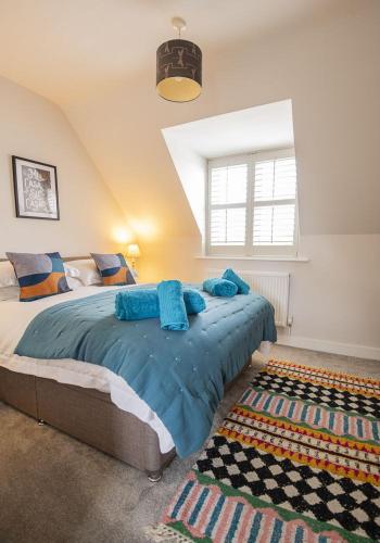 a bedroom with a large bed and a window at Gad About in Woodbridge