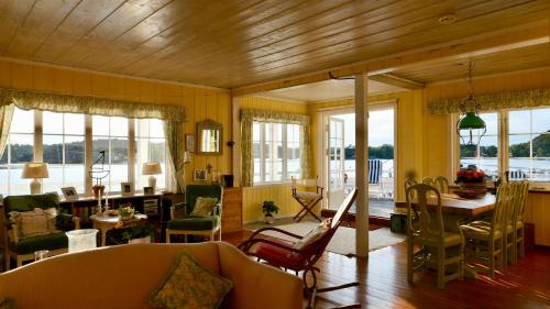 a living room with yellow walls and wooden ceilings at Cabin With Sunset Views And Private Dock in Sandefjord
