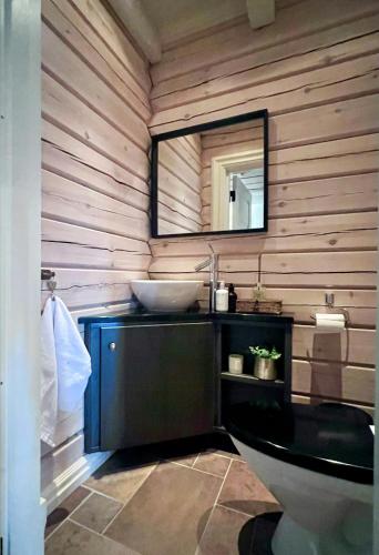 a bathroom with a sink and a mirror at Mountain Cabin With Panoramic Views At Hummelfjell in Os