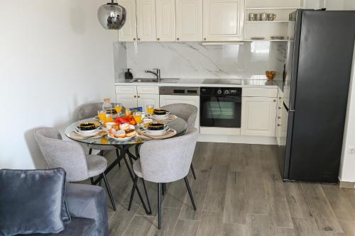 a kitchen with a table with food on it at City Apartment Posušje in Posušje