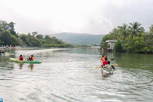 a group of people in kayaks on a river at Mafiya Resort in Koh Rong Island