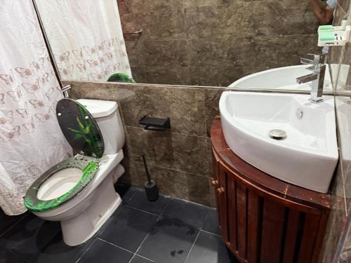 a bathroom with a toilet and a sink at Perivale Budget Stay in Moratuwa