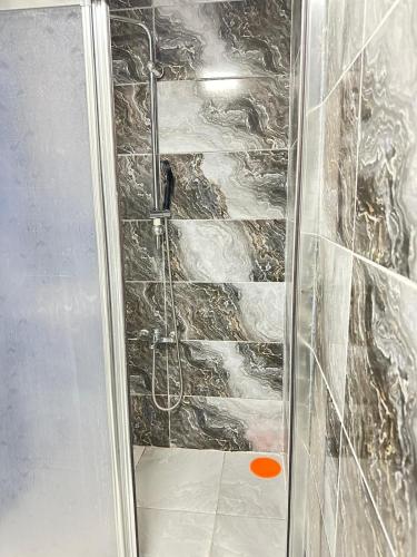 a shower with a glass door in a bathroom at Upart Flats by REFE in Antalya