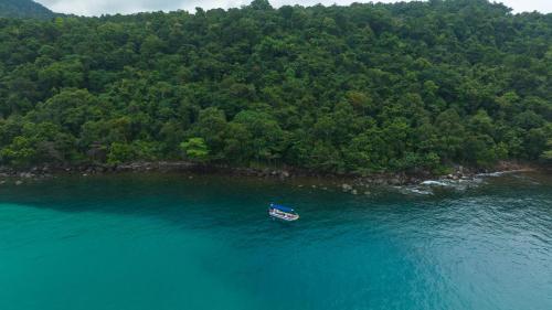a small boat in the middle of a body of water at Mafiya Resort in Koh Rong Island