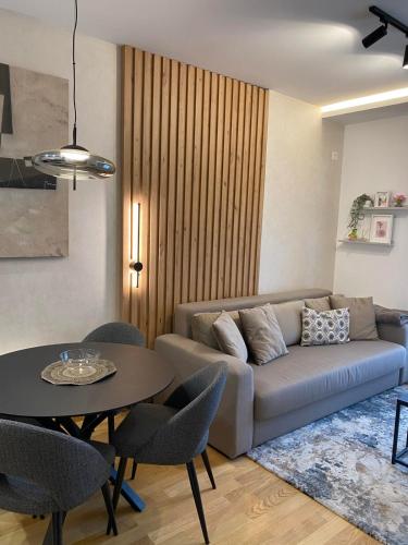 a living room with a couch and a table at Titova Vila - Golden Peak Residence in Zlatibor