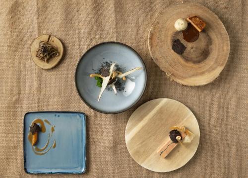 a group of plates of food on a table at Le Domaine Du Colombier in Malataverne
