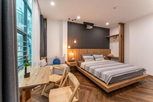 a bedroom with a large bed and a table at Hanoian Hearths - 5 Bedrooms - Bath Tubs - Projectors in Hanoi