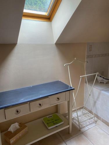 a bathroom with a blue counter and a window at Gite les Merlettes in Abbecourt