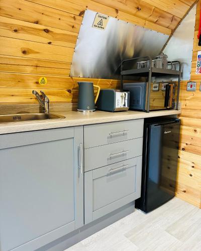 a kitchen with a sink and a stove at Brora Escapes in Brora