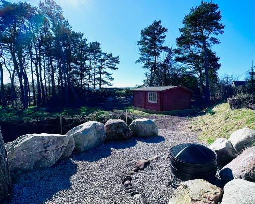 a fire pit and some rocks and a house at Brora Escapes in Brora