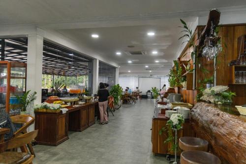 a restaurant with people sitting at tables in a room at Mafiya Resort in Koh Rong Island