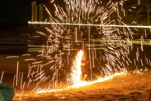 a firework display with sparks in the background at night at Mafiya Resort in Koh Rong Island