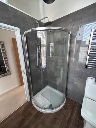a shower with a glass door in a bathroom at Brighton Rock Retreat in Brighton & Hove