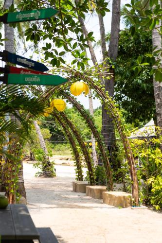 an archway with street signs in a park at Mafiya Resort in Koh Rong Island