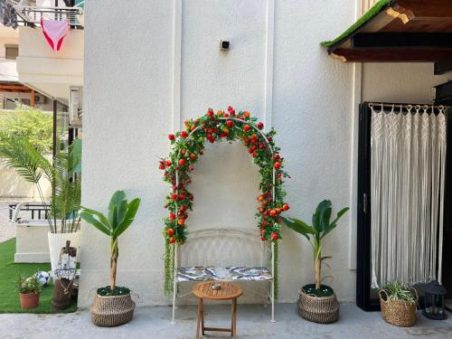 an arch with red flowers and plants on a building at Villa La Mer Durres in Durrës