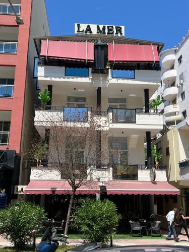 a building with a sign on the side of it at Villa La Mer Durres in Durrës