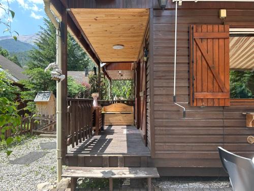 a wooden walkway leading to a house with a wooden door at Horizon Nature - WIFI - Jardin in Jausiers