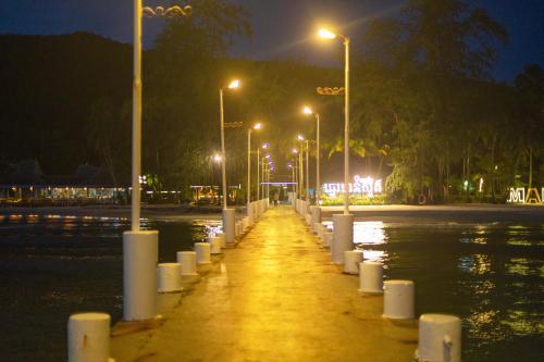 a flooded street at night with lights on the water at Mafiya Resort in Koh Rong Island
