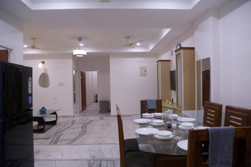 a dining room with a table and chairs in a room at Siddhartha Enclave 3bhk-Madhapur, Hyderabad in Hyderabad