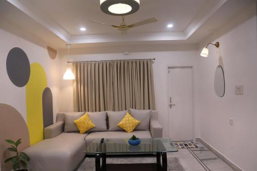 a living room with a couch and a table at Siddhartha Enclave 3bhk-Madhapur, Hyderabad in Hyderabad