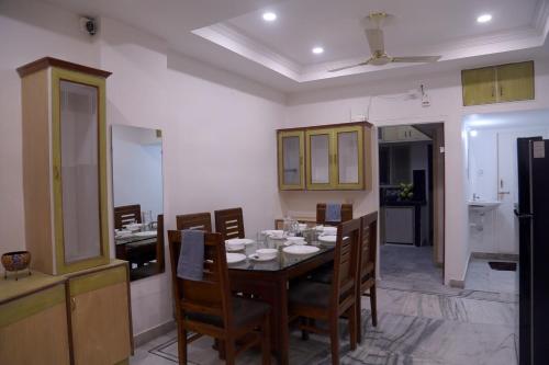 a kitchen and dining room with a table and chairs at Siddhartha Enclave 3bhk-Madhapur, Hyderabad in Hyderabad