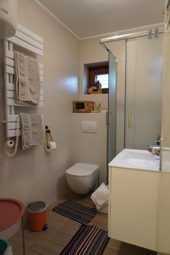 a small bathroom with a toilet and a sink at Apartments Krnjic in Umag