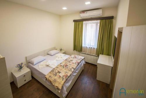 a small bedroom with a bed and a window at Armenian Inn in Yerevan