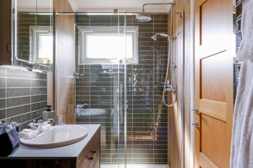 a bathroom with a sink and a shower at Seaham Hall and Serenity Spa in Seaham