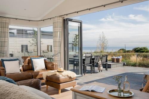 a living room with a view of the ocean at Seaham Hall and Serenity Spa in Seaham