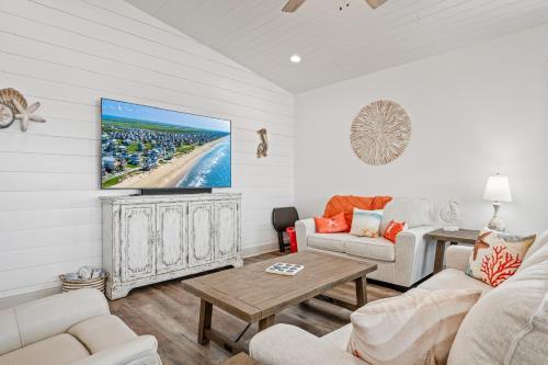 a living room with a couch and a tv at Breeze Easy home in Crystal Beach