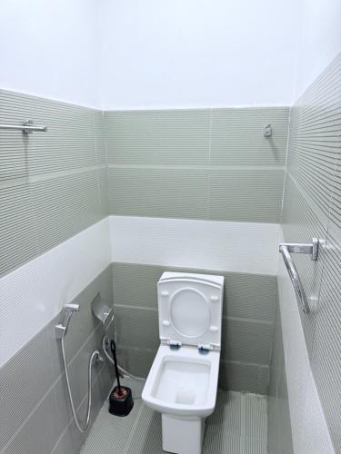 a bathroom with a white toilet in a stall at NO 10 Kandy by Kepler & Earth in Kandy