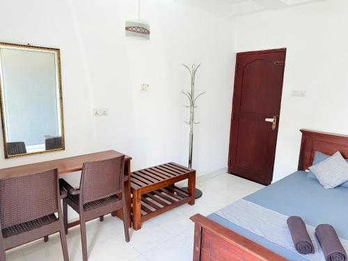 a bedroom with a desk and a bed and a mirror at NO 10 Kandy by Kepler & Earth in Kandy