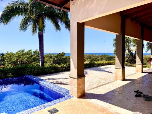 a house with a swimming pool and a palm tree at Villa Casa Modelo in Marbella