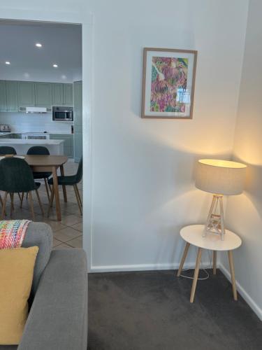 a living room with a couch and a table at Family home central to everything in Mildura