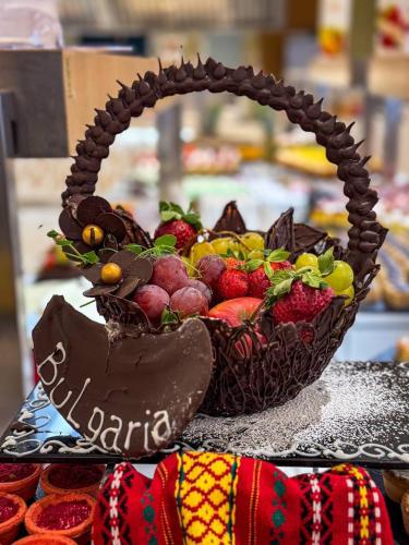 a basket of fruit sitting on top of a table at Astoria Hotel All Inclusive- Free parking, Private Beach & Beach Club in Golden Sands