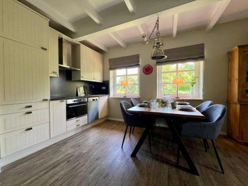 a kitchen with a table and chairs in a room at FERIENWOHNUNG HOLST – SYLT (Braderup) in Braderup