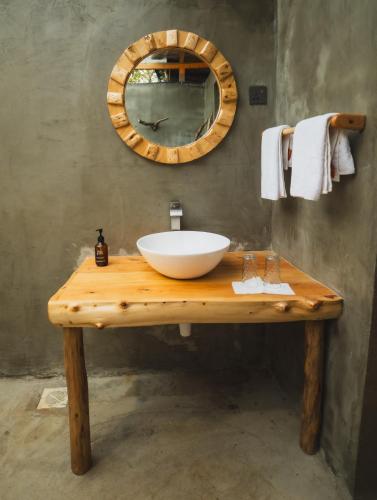 a bathroom with a bowl sink on a wooden table at Mara Hilltop in Sekenani