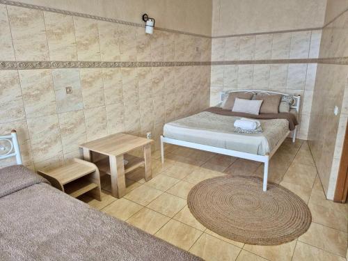 a small bedroom with two beds and a table at Dream Apartments in Kyiv