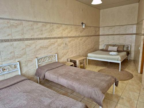 a room with two beds and a table in it at Dream Apartments in Kyiv