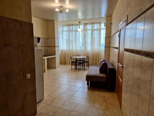 a kitchen and dining room with a table and a chair at Dream Apartments in Kyiv