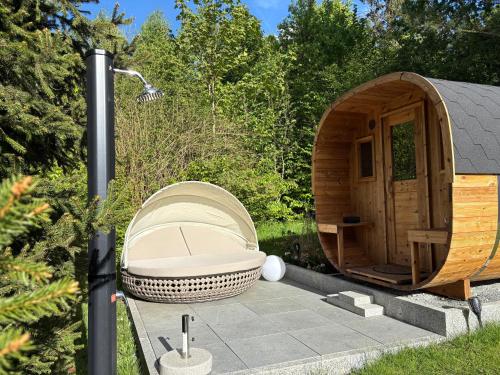 a hot tub sitting next to a wooden building at Komfortables Ferienhaus in Lichtenberg bei Hof im Frankenwald 400m vom See nahe Bad Steben in Lichtenberg