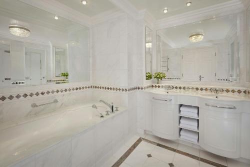 a white bathroom with a tub and a sink at Powerscourt Hotel, Autograph Collection in Enniskerry