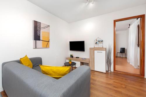 a living room with a couch and a television at Apartments Luce in Rovinj